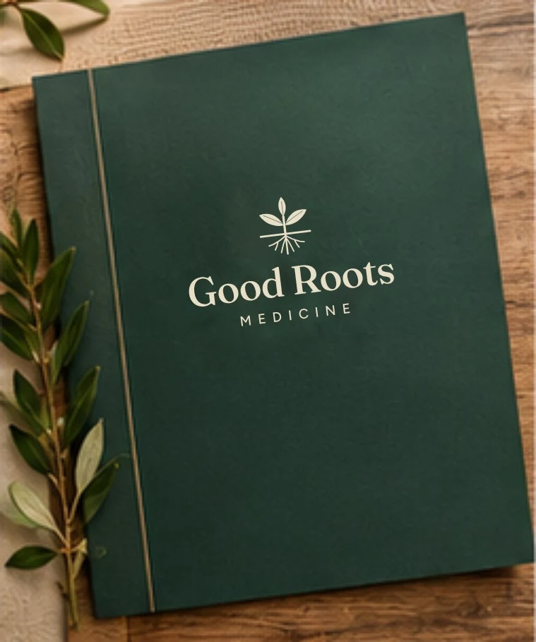 Good Roots Medicine identity on a forest-green folder with botanical details